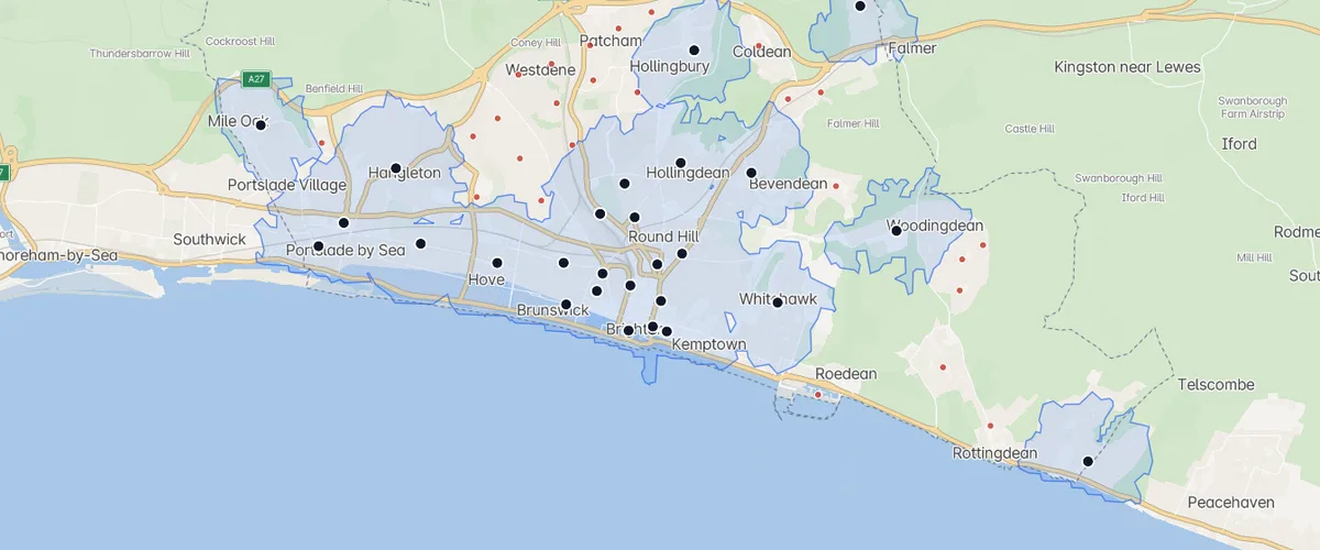Brighton with a blue 15-minute walking coverage area around every GP practice, red dots marking the neighbourhoods beyond reach.