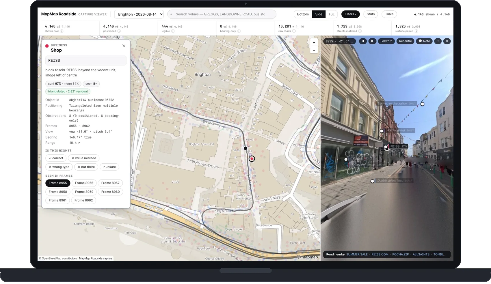 A laptop running the MapMap Roadside capture viewer on the Brighton pass: the record card for a REISS shopfront open beside the map, read at 97 per cent confidence and triangulated from eight bearings across frames 8955 to 8962, with the side-facing 360 frame on the right where the REISS fascia carries its own reading chip · © OpenStreetMap contributors © OpenMapTiles