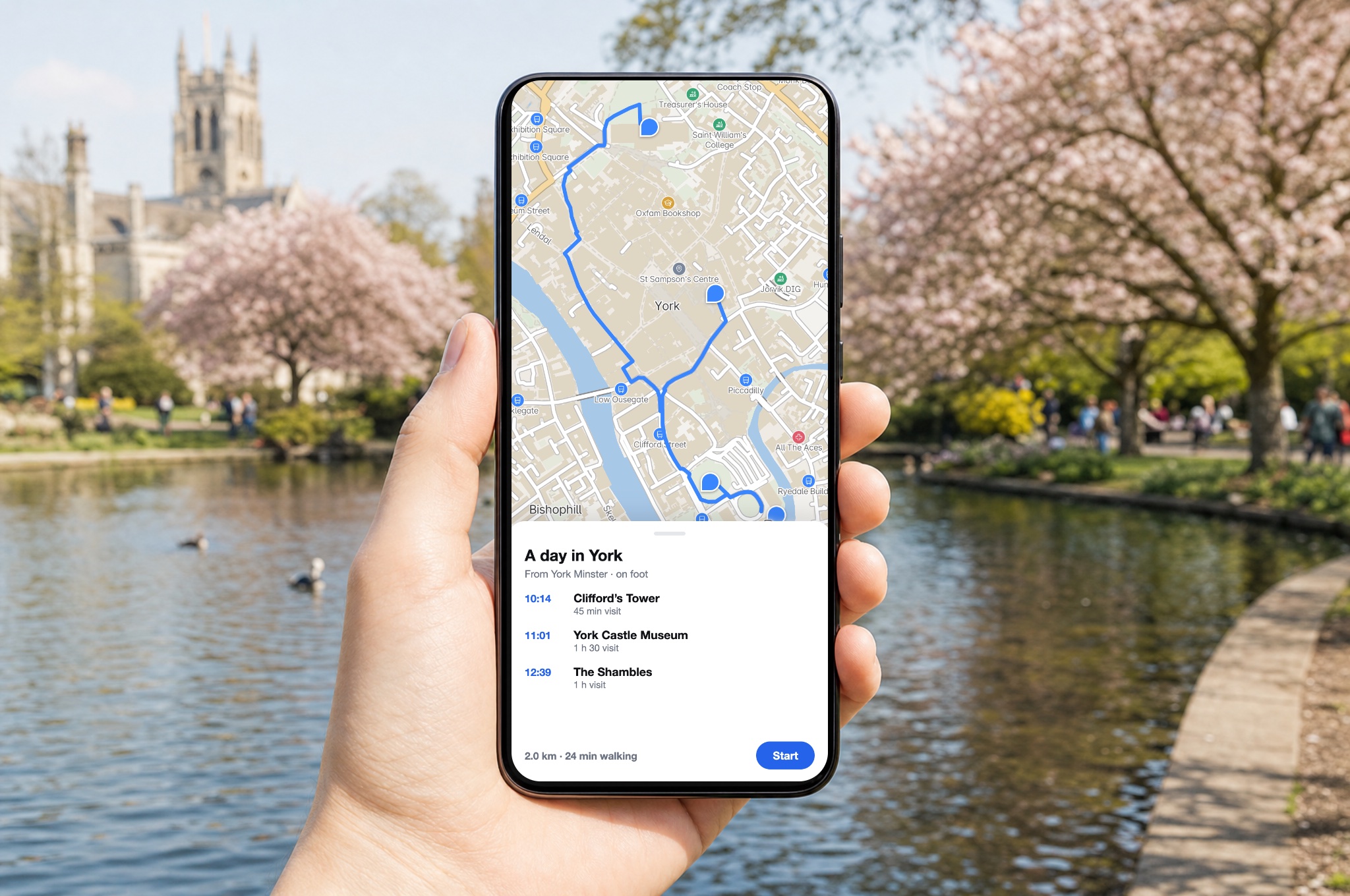 A hand holding a phone in a blossom-filled park; the screen shows a real MapMap walking route through York with a three-stop itinerary and genuine arrival times